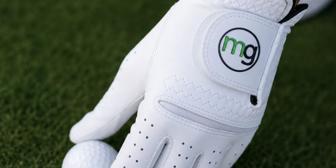 Close-up of a worn golf glove on a club grip