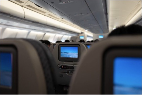 Delta aircraft cabin with seatback entertainment screens